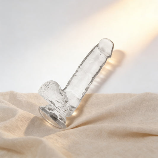 Gode transparent X-Ray avec testicules sur du lin, fond crème